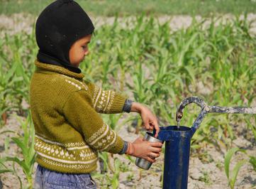 Child at water pump in Bihar, India.