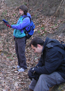 foreground student is resting while background student uses GPS receiver