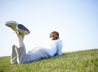 A student lying in the grass